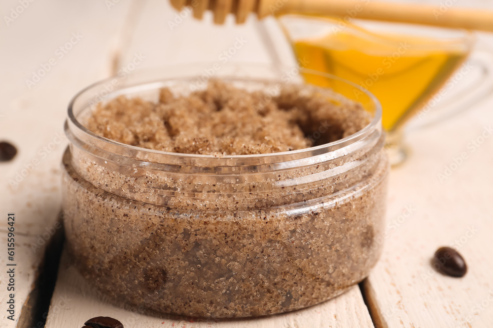 Jar of body scrub on light wooden background, closeup