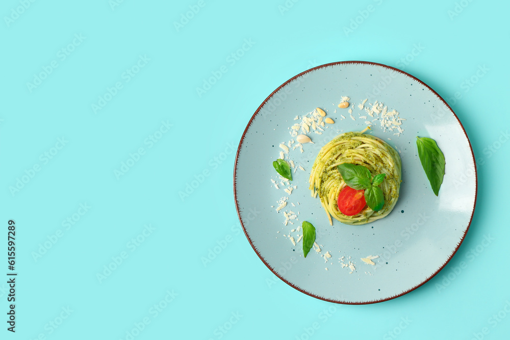 Plate with tasty pesto pasta on color background