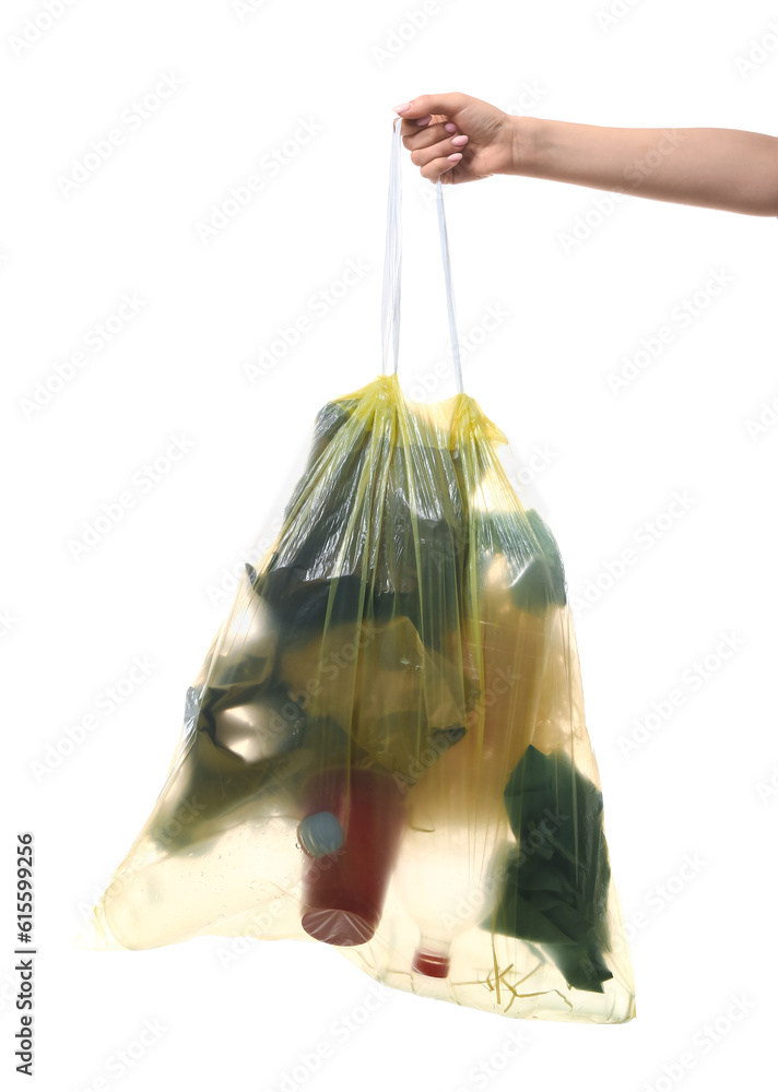 Female hand holding full garbage bag isolated on white background