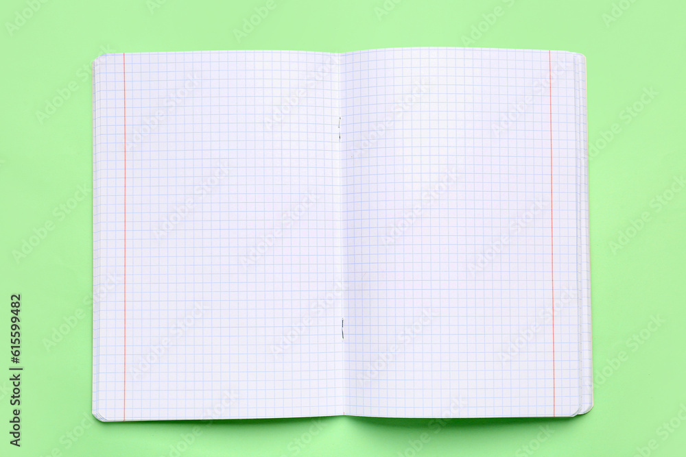 Blank copybook pages on green background