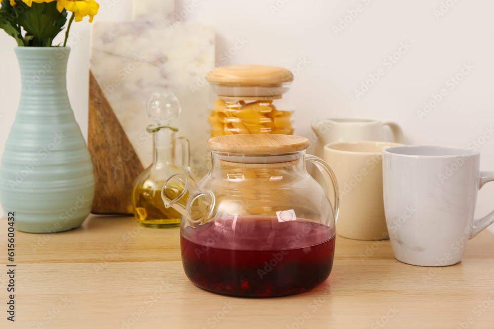 Teapot and different kitchen stuff on wooden table