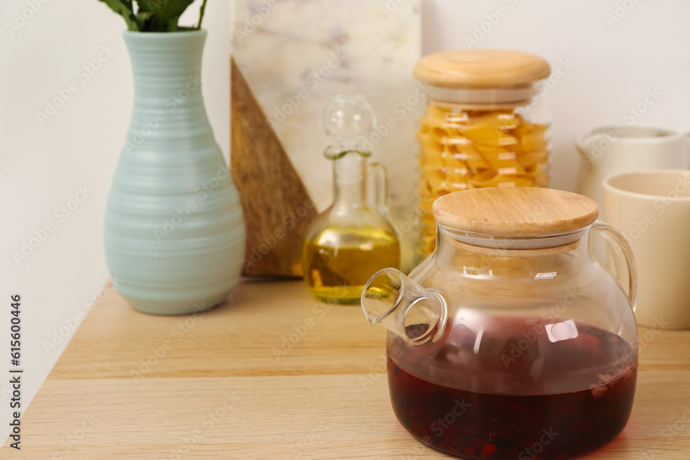 Teapot and different kitchen stuff on wooden table