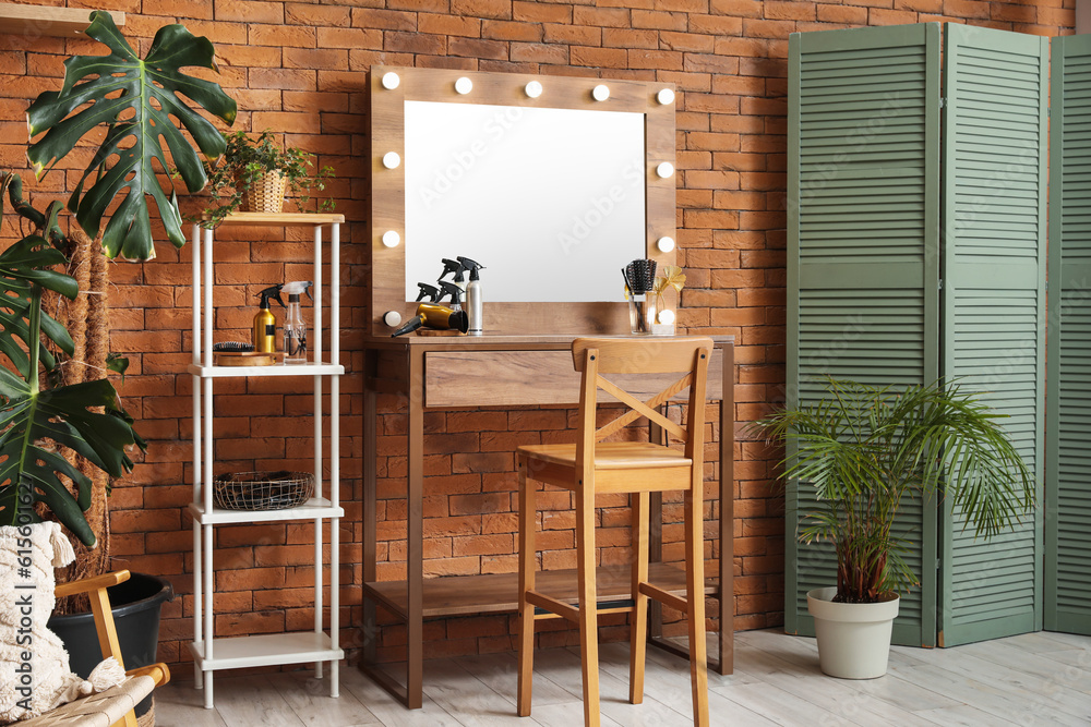 Modern hairdresser workplace near brick wall