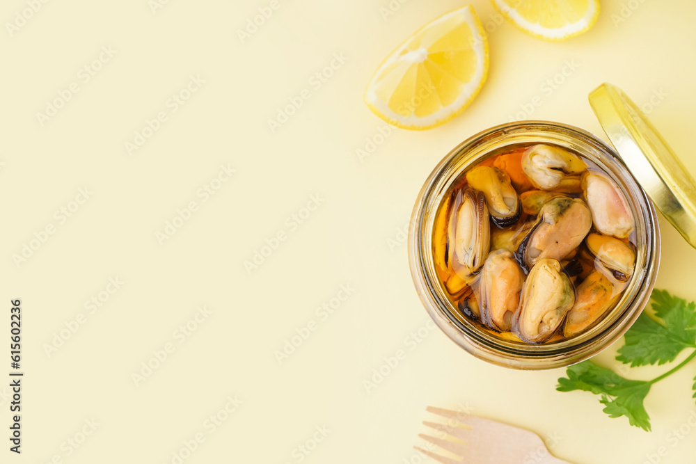 Jar with pickled mussels on beige background