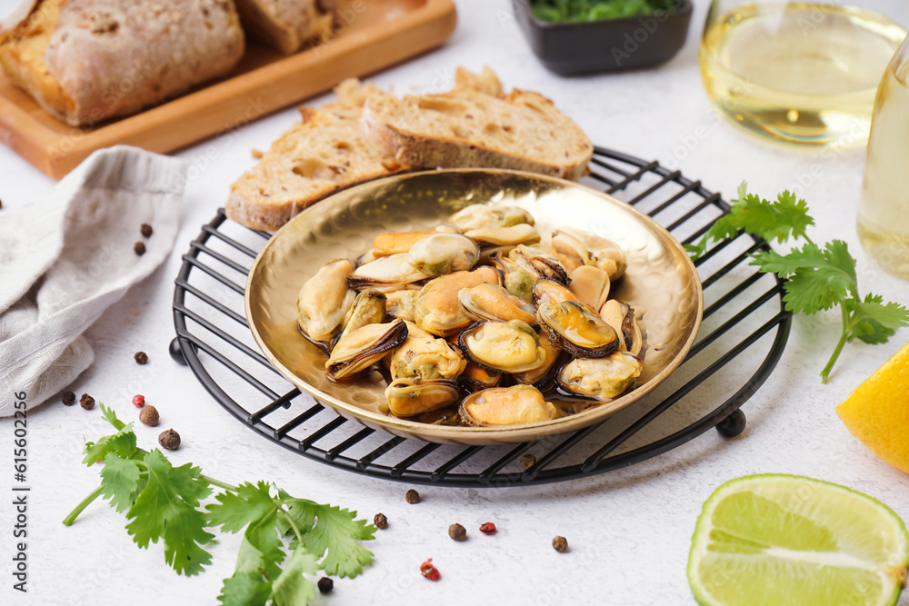 Plate of pickled mussels on grey background