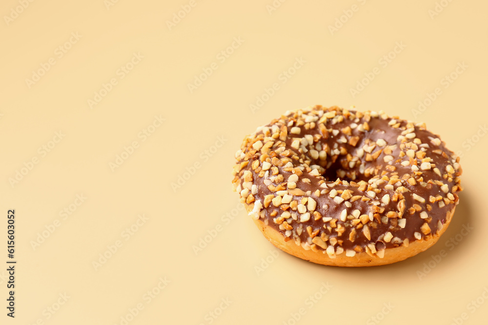 Sweet chocolate donut on beige background