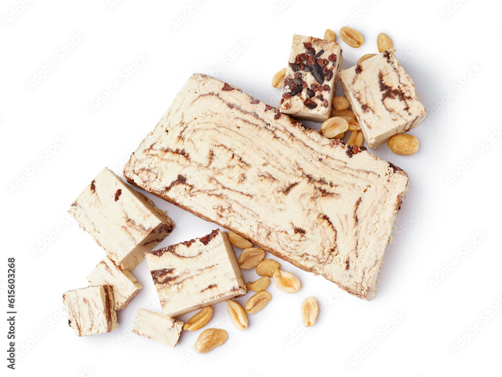 Pieces of tasty marble halva with peanuts on white background