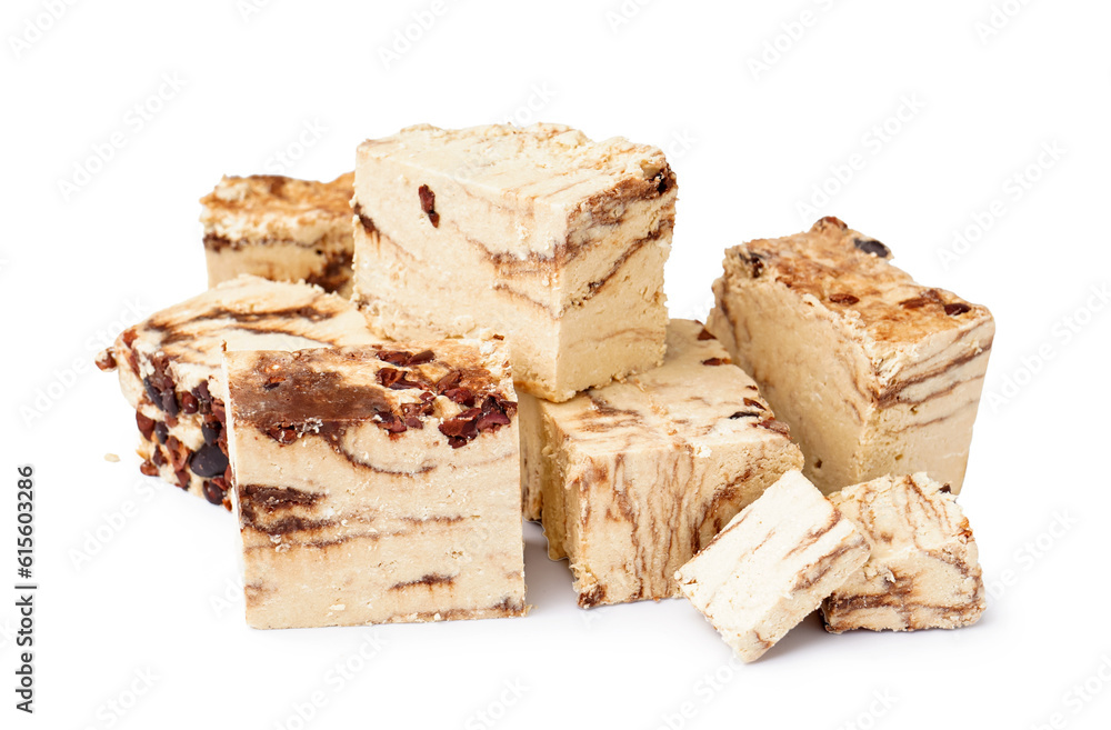 Pieces of tasty marble halva on white background