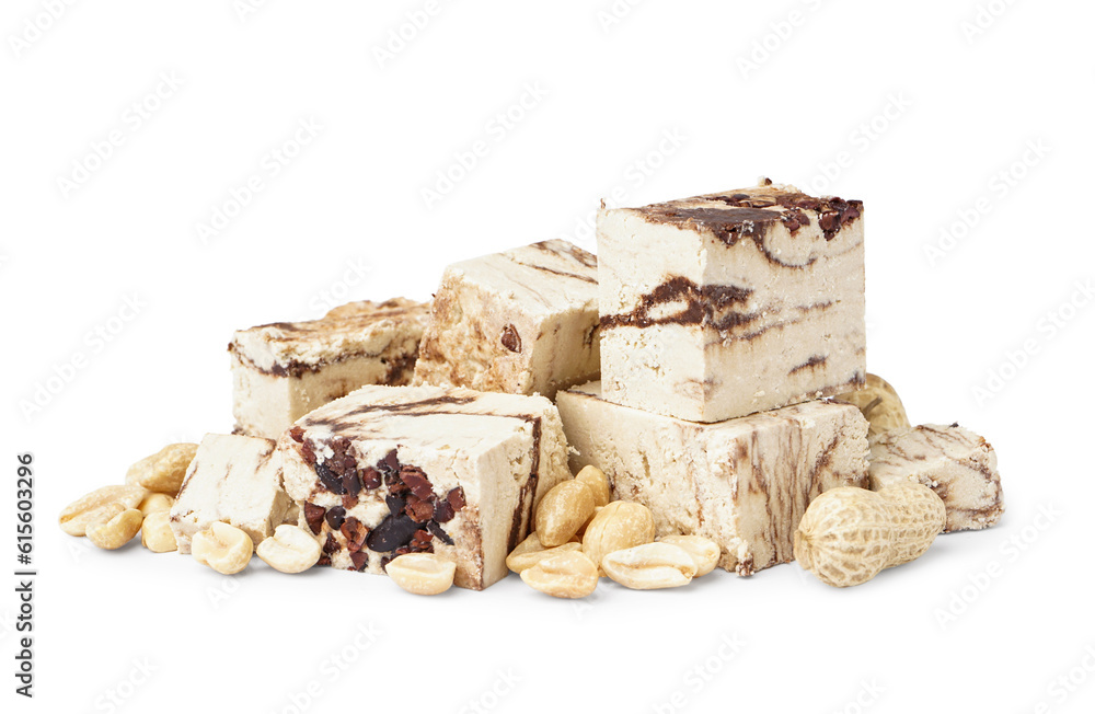 Pieces of tasty marble halva with peanuts on white background