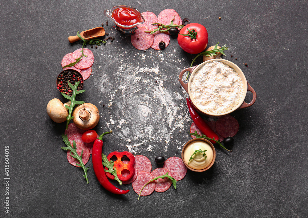 Different ingredients for preparing pizza on dark background