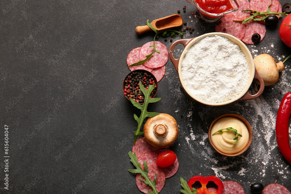 Different ingredients for preparing pizza on dark background