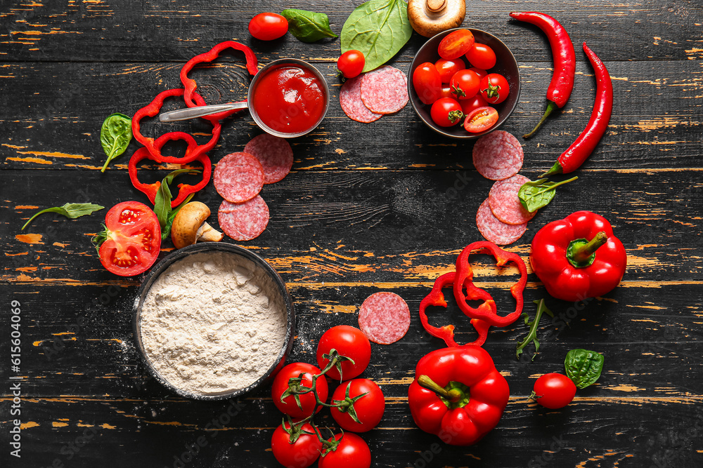 Frame made of fresh ingredients for preparing pizza on dark wooden background