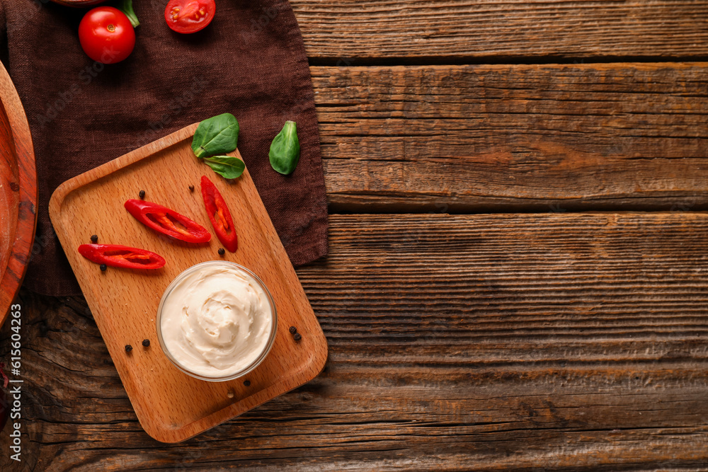 Bowl of tasty cream cheese on wooden background