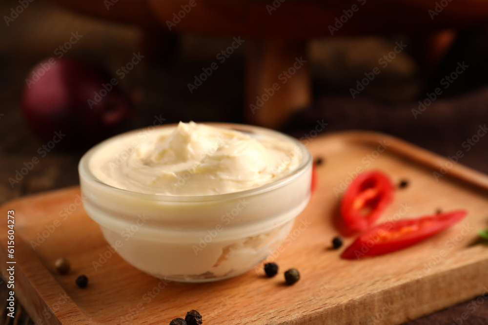 Bowl of tasty cream cheese on table