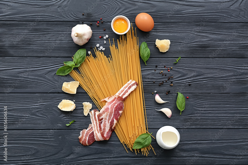 Ingredients for delicious pasta carbonara on dark wooden background