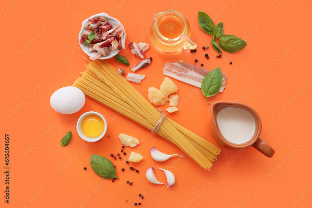 Ingredients for tasty pasta carbonara on orange background