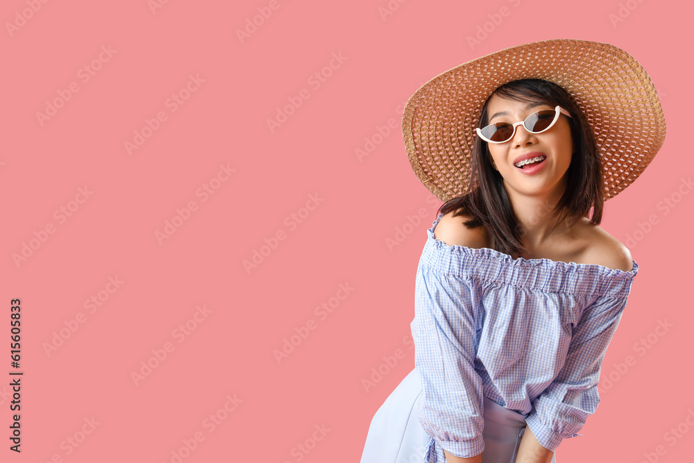 Beautiful Asian woman in stylish sunglasses on pink background