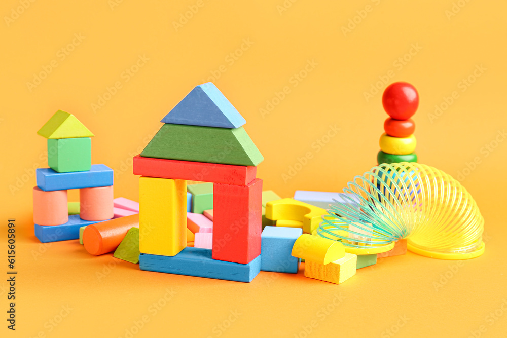 Different colorful toys on orange background. Childrens Day celebration