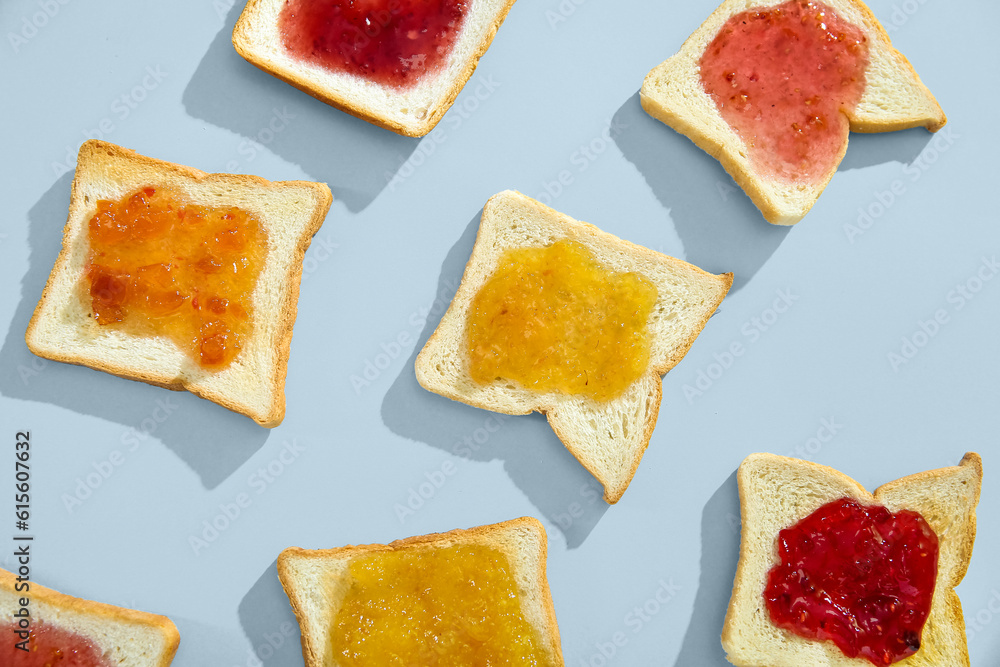 Delicious toasts with different jams on light background, closeup