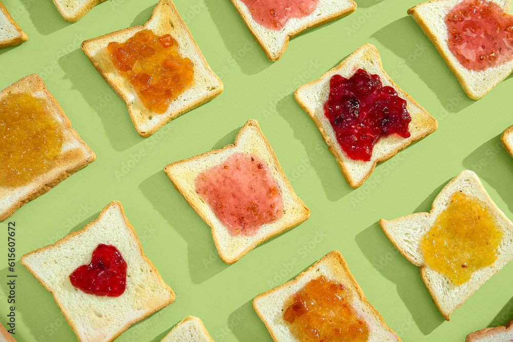 Many toasts with different jams on green background