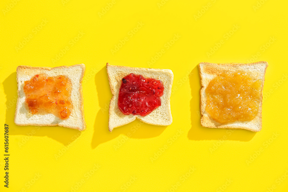 Tasty toasts with jams on yellow background