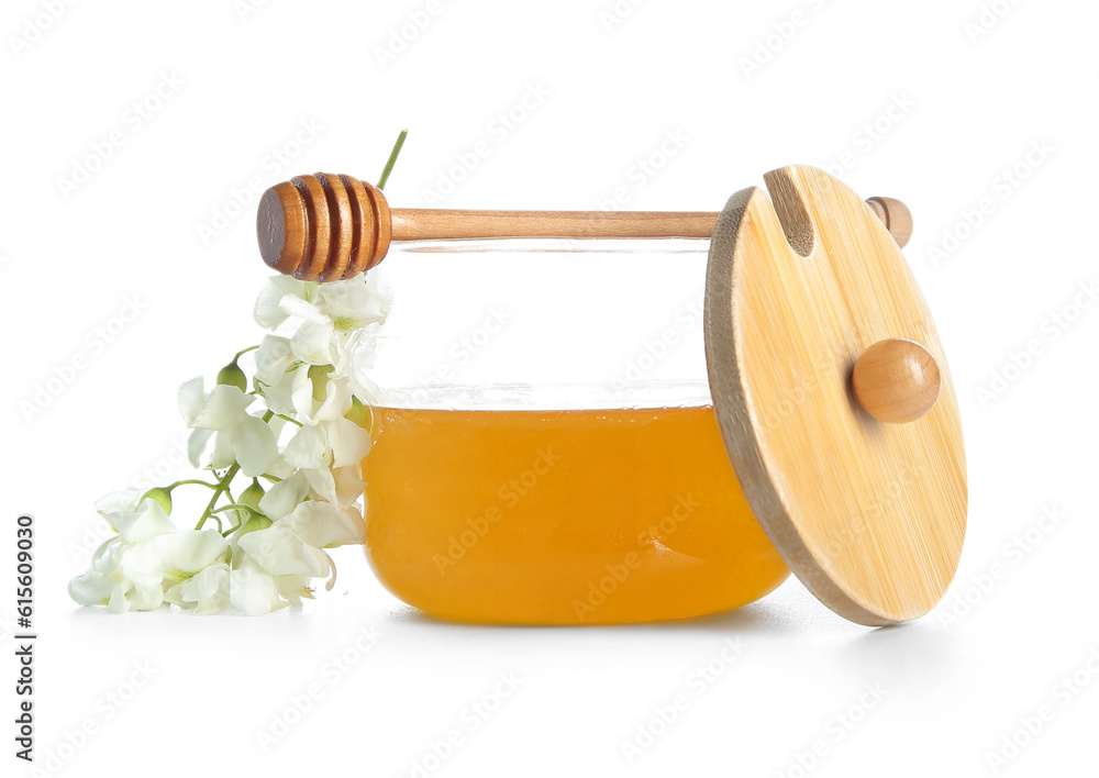 Jar of honey with flowers of acacia on white background