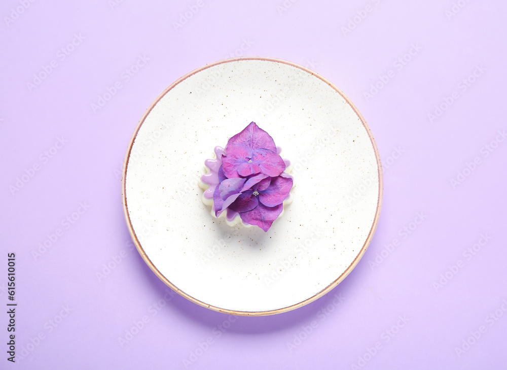 Plate of panna cotta with beautiful hydrangea flowers on lilac background