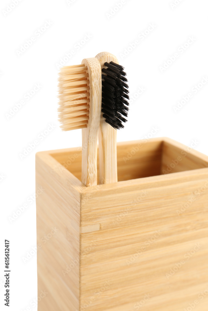 Bamboo tooth brushes in holder on white background, closeup