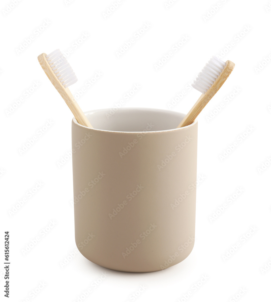 Bamboo tooth brushes in holder on white background