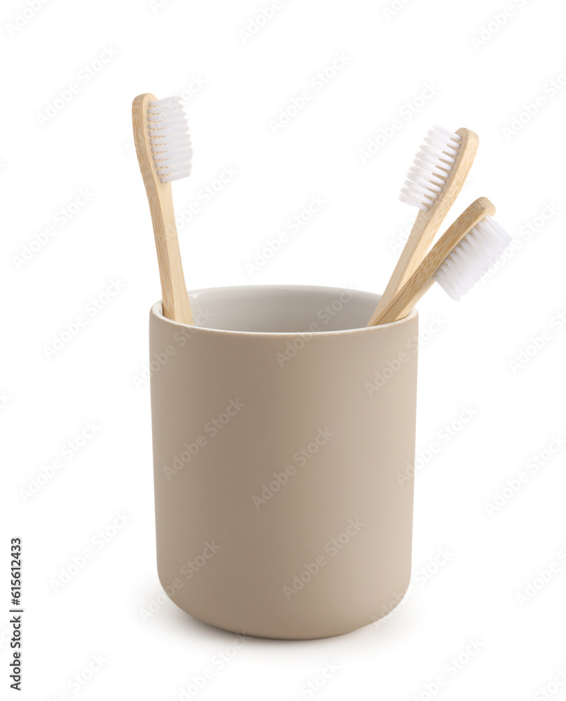 Bamboo tooth brushes in holder on white background