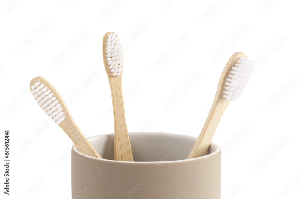 Bamboo tooth brushes in holder on white background, closeup