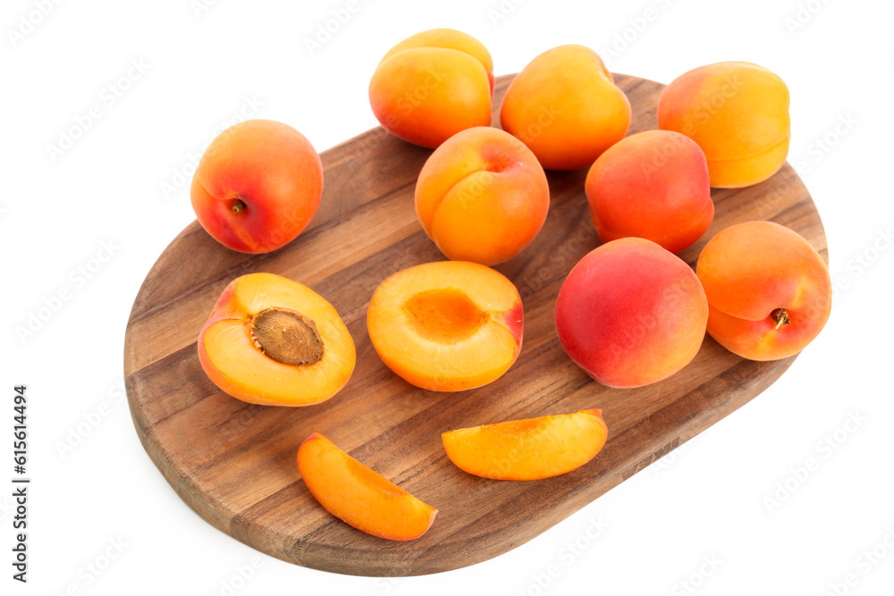 Wooden board with ripe apricots isolated on white background