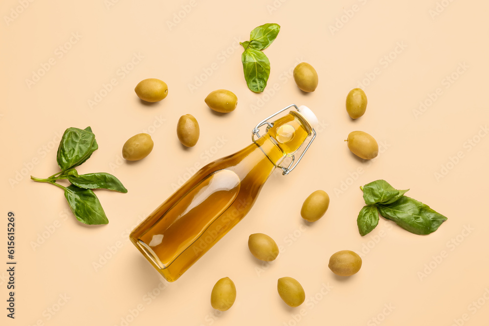 Bottle of fresh olive oil on beige background