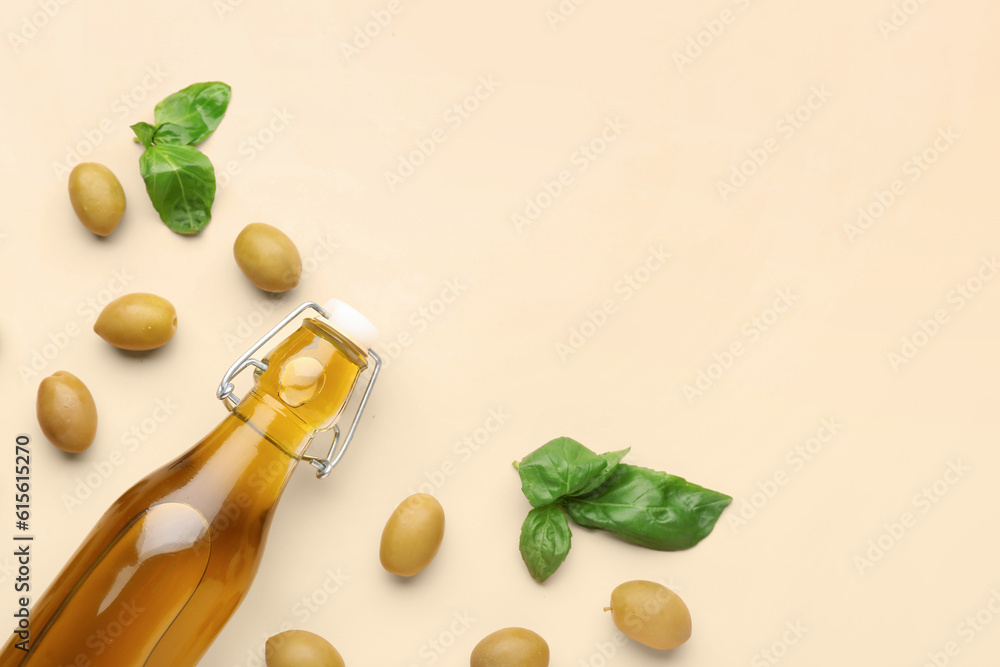 Bottle of fresh olive oil on beige background