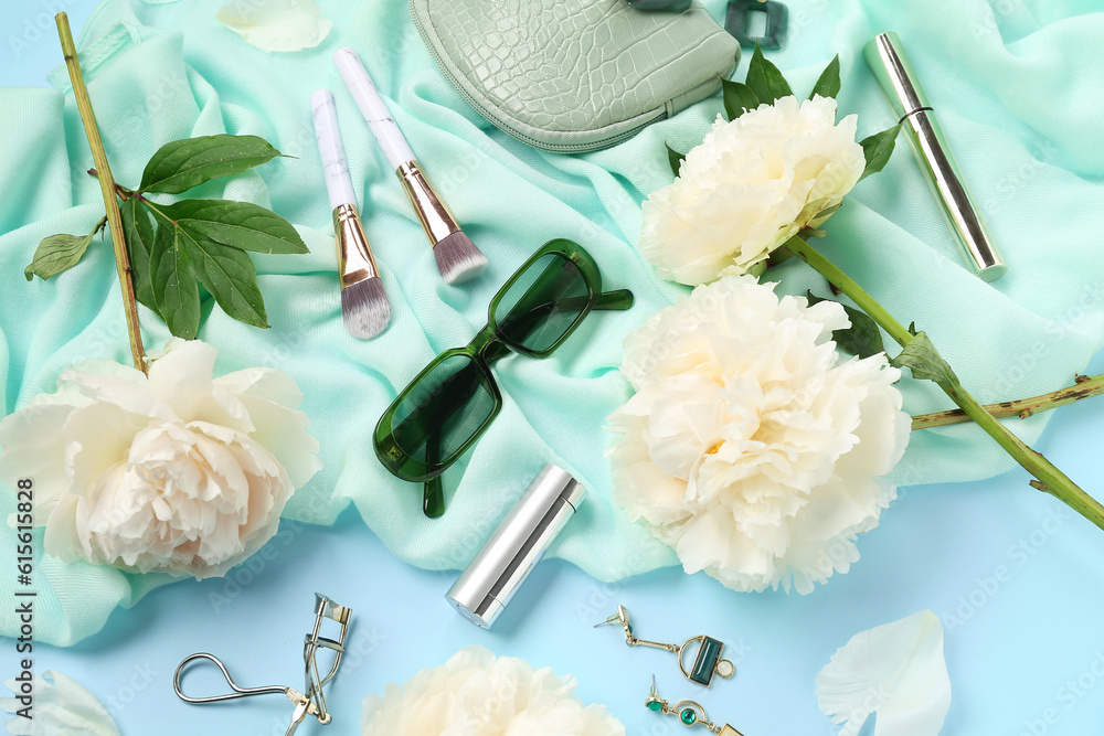 Composition with stylish female accessories, cosmetics and beautiful peony flowers on color backgrou