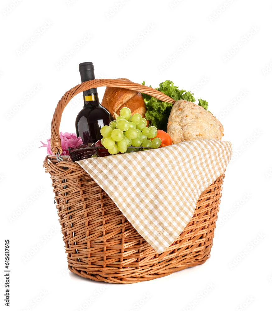 Wicker basket with tasty food for picnic and wine on white background