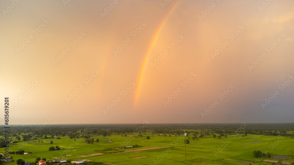 Green field and rainbow background, dark light, select focus.