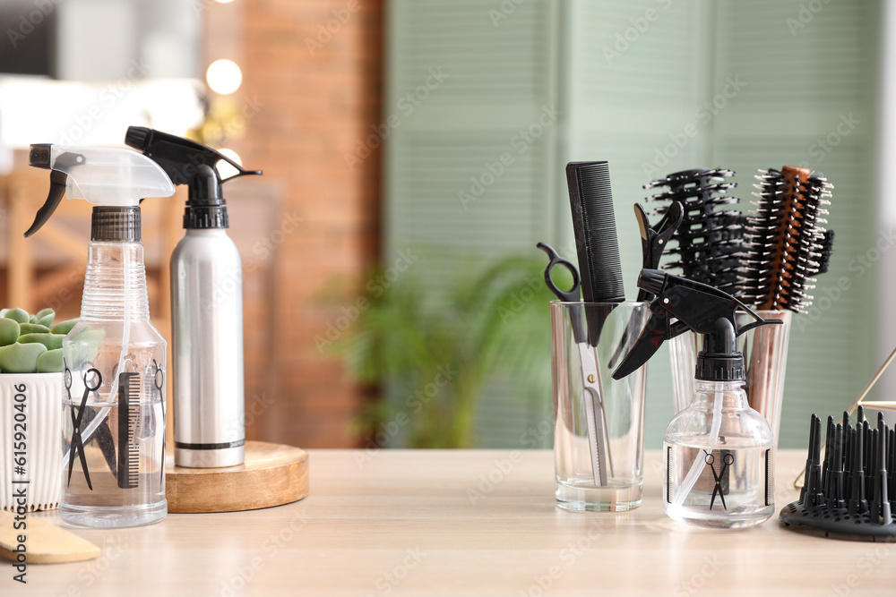 Different hairdressing tools on table in beauty salon