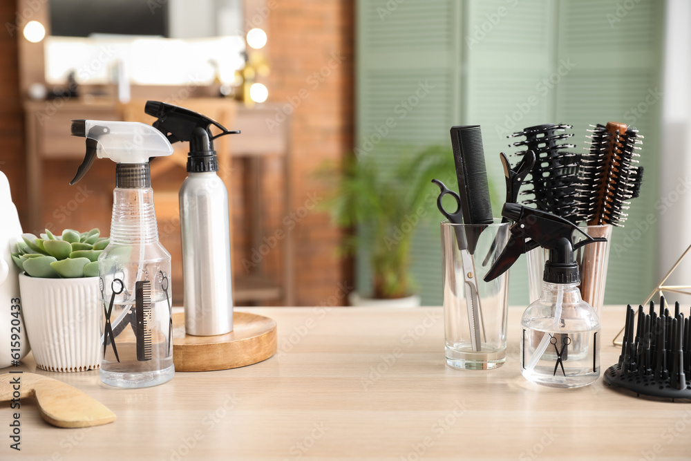 Different hairdressing tools on table in beauty salon