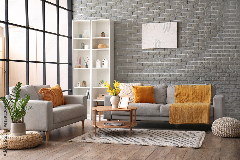 Interior of modern living room with sofas, coffee table and shelving unit