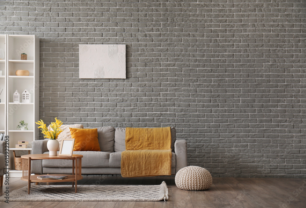 Interior of modern living room with sofa, coffee table and shelving unit