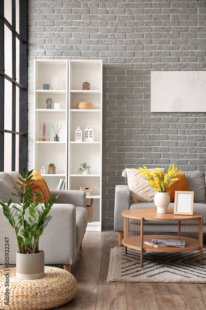 Interior of modern living room with sofas, coffee table and shelving unit