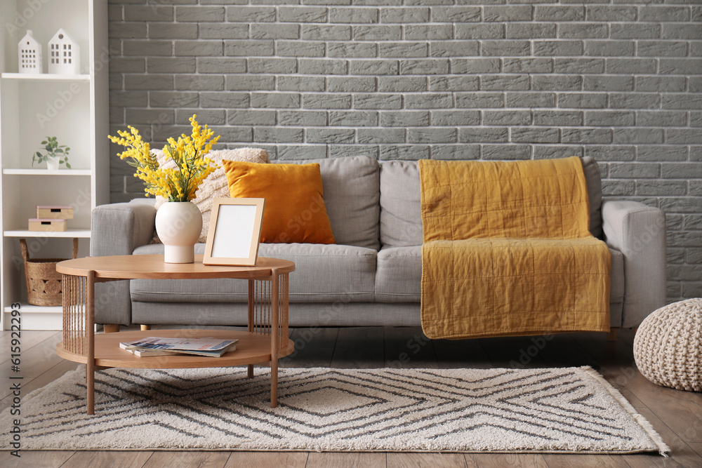 Interior of modern living room with sofa, coffee table and shelving unit