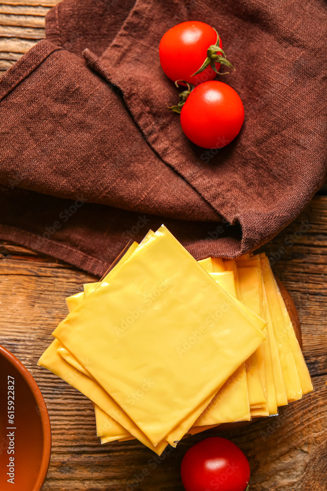 Slices of tasty processed cheese on wooden background