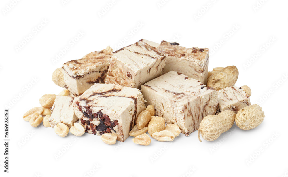 Pieces of tasty marble halva with peanuts on white background