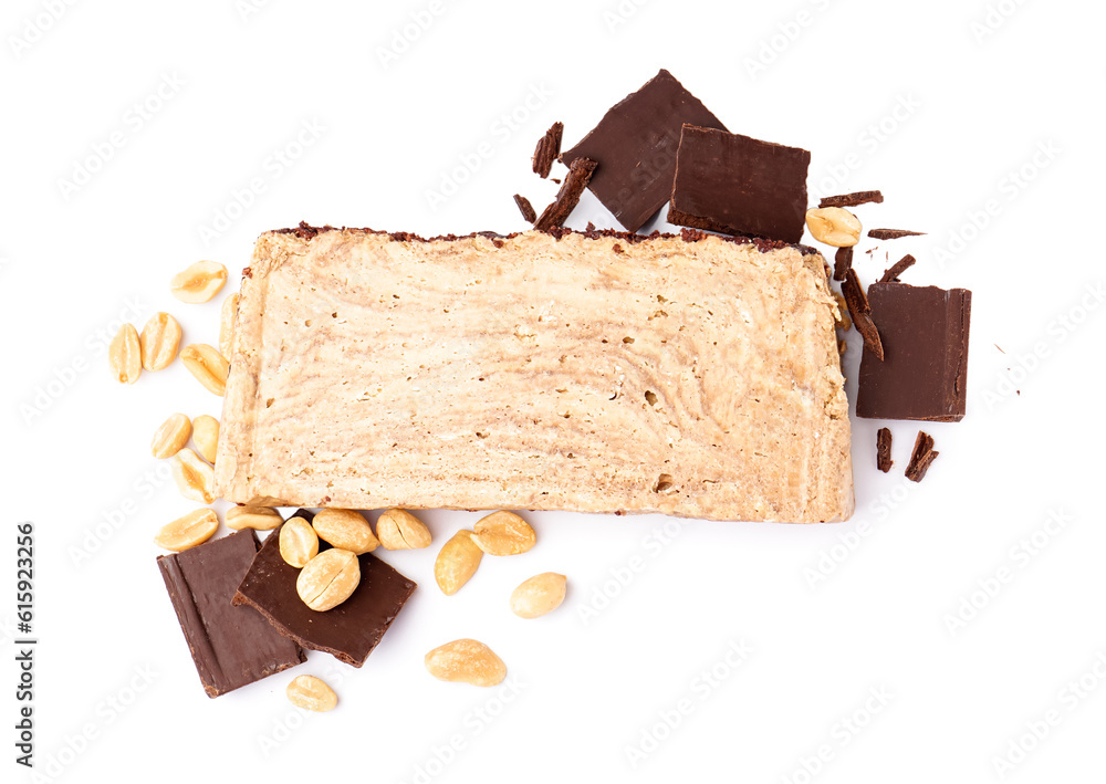 Piece of tasty marble halva with chocolate and peanuts on white background