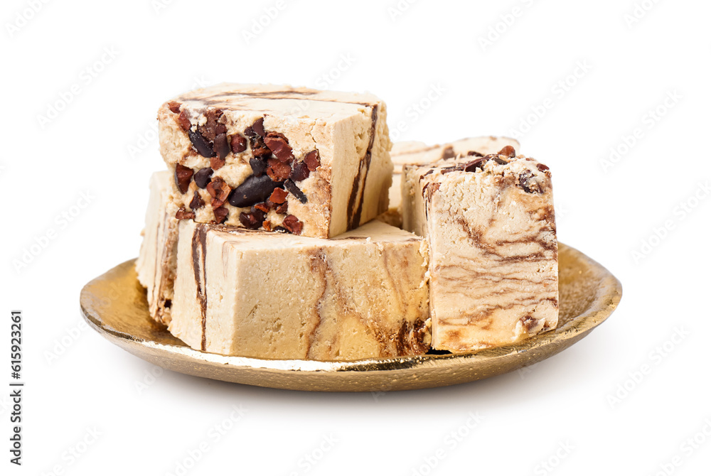 Plate with pieces of tasty marble halva on white background