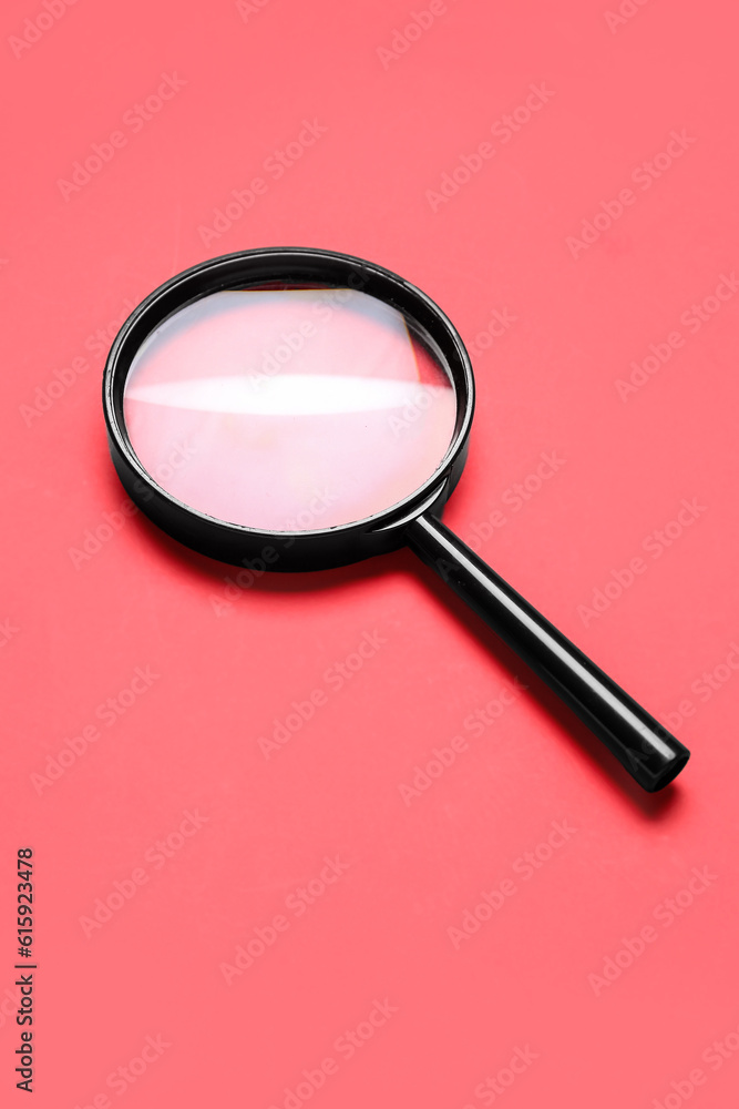 Black magnifier on red background