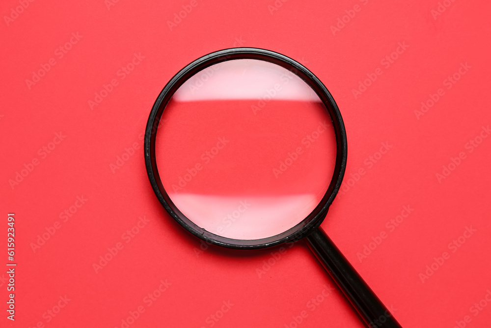 Black magnifier on red background