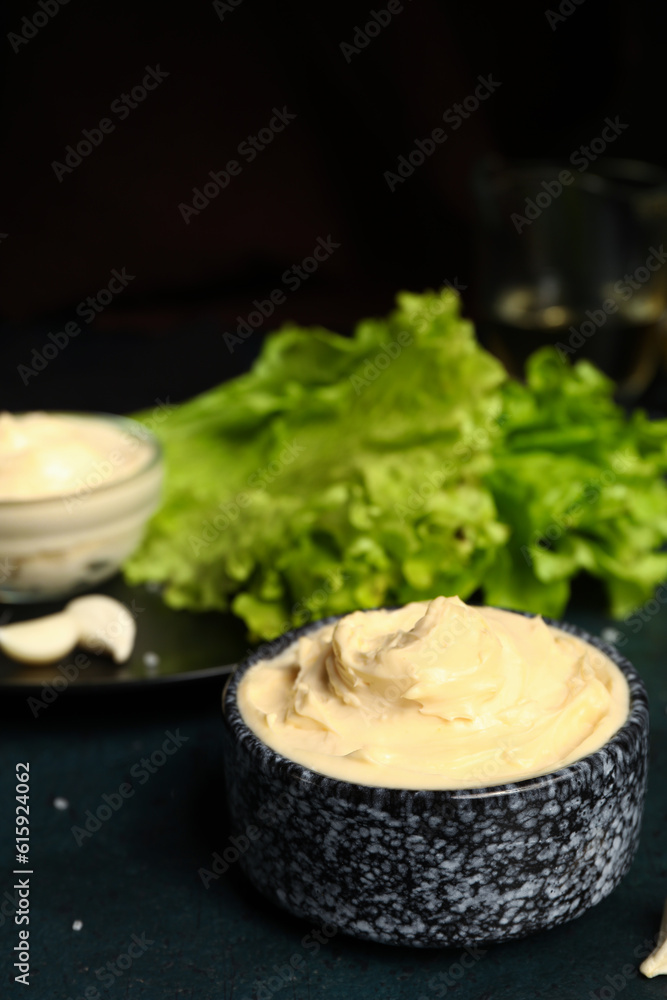 Bowl of tasty cream cheese on dark background